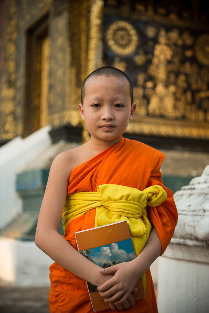 Buddhist Monk outside Wat Xieng Thong, Luang Prabang, Laos, Indochina, Asia