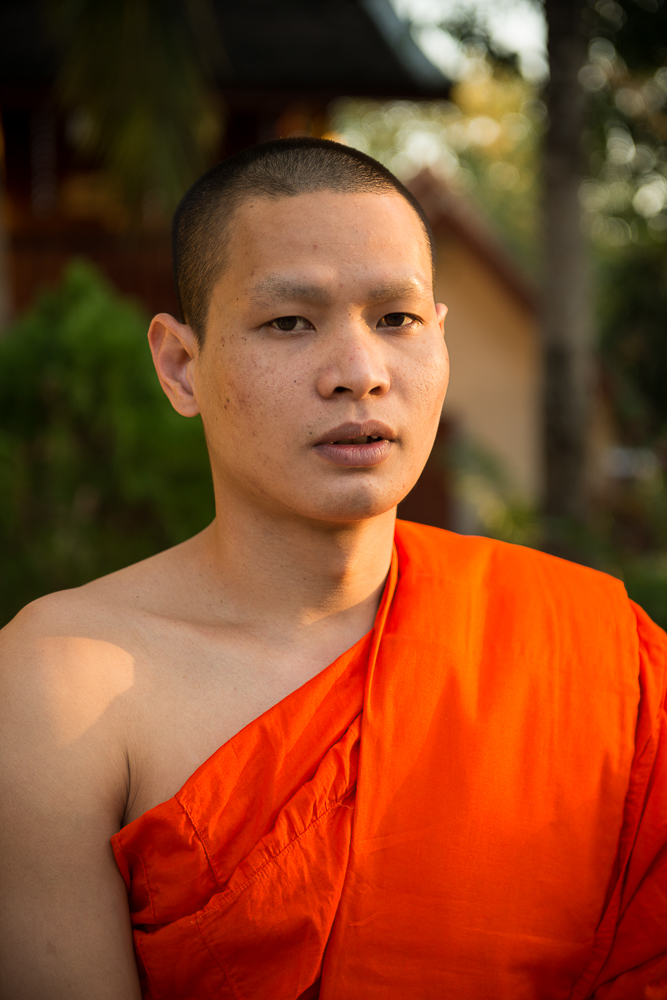 Buddhist Monk outside Wat Xieng Thong, Luang Prabang, Laos, Indochina, Asia