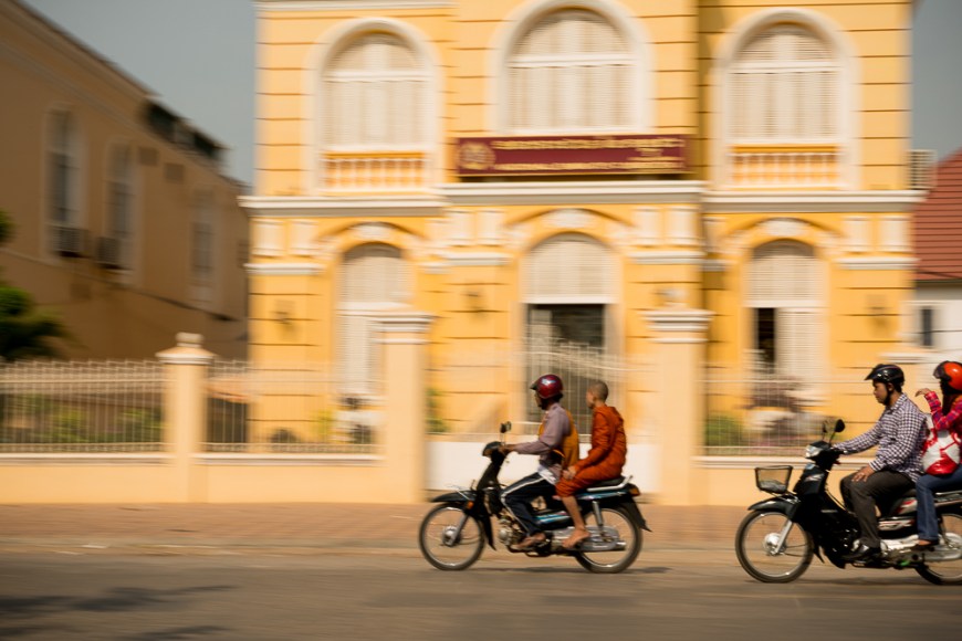 Panning shots of traffic outside Colonial style buildings, Battambang, Battambang Province, Cambodia, Indochina, Asia