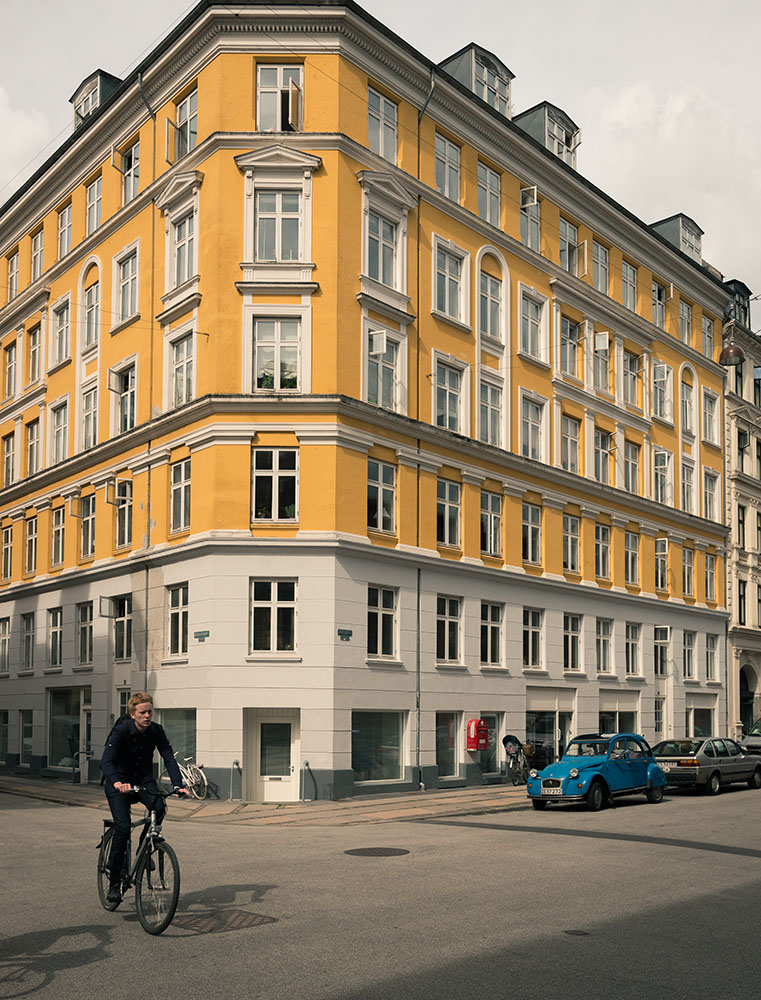 Person cycling through street, Nørrebro, Central Copenhagen, Denmark