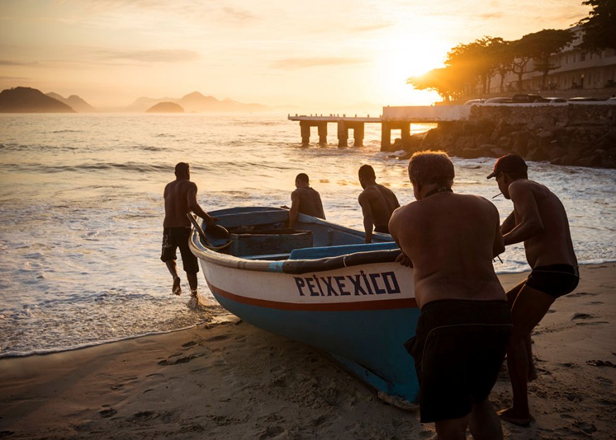 Fishermen taking their boat out at dawn, Copacabana, Rio de Janeiro, Brazil