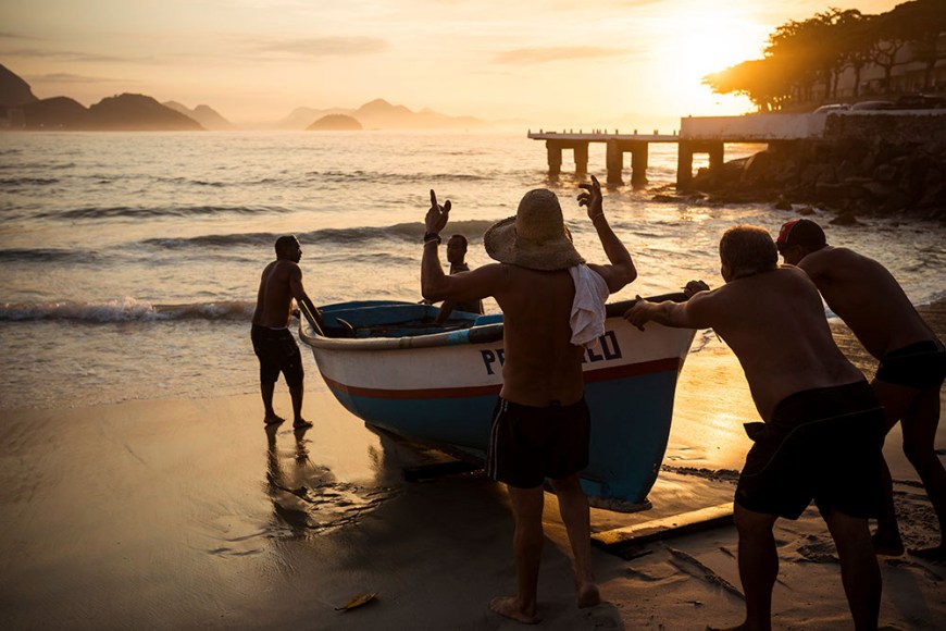 Fishermen taking their boat out at dawn, Copacabana, Rio de Janeiro, Brazil