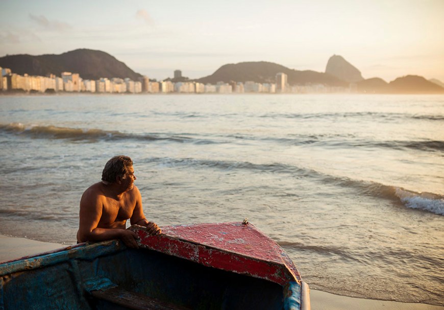 Fishermen taking their boat out at dawn, Copacabana, Rio de Janeiro, Brazil