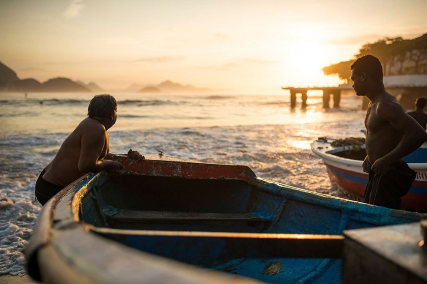 Fishermen taking their boat out at dawn, Copacabana, Rio de Janeiro, Brazil
