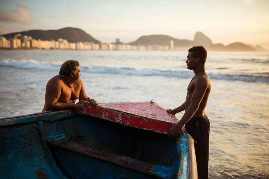 Fishermen taking their boat out at dawn, Copacabana, Rio de Janeiro, Brazil