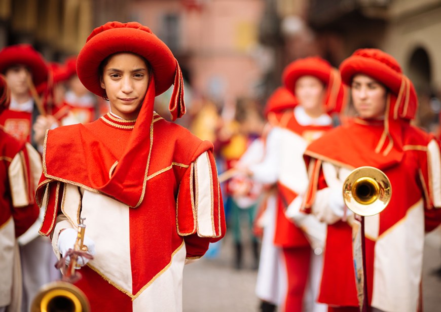 Children in Medieval costume parading through the streets of Asti