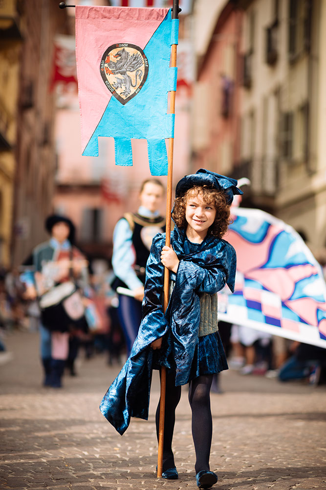 Children in Medieval costume parading through the streets of Asti