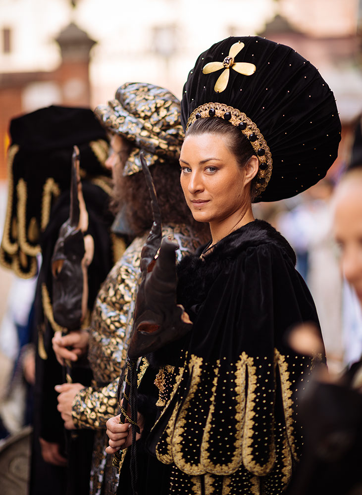 Portrait of young woman in traditional medieval costume ahead of the Palio di Asti