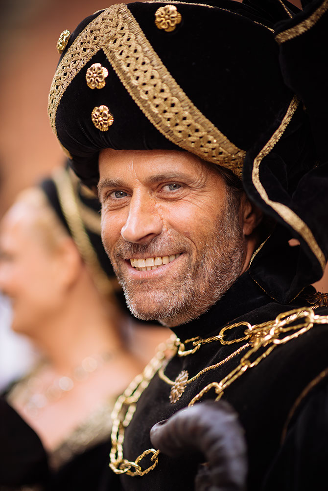 Portrait of man in traditional medieval costume ahead of the Palio di Asti