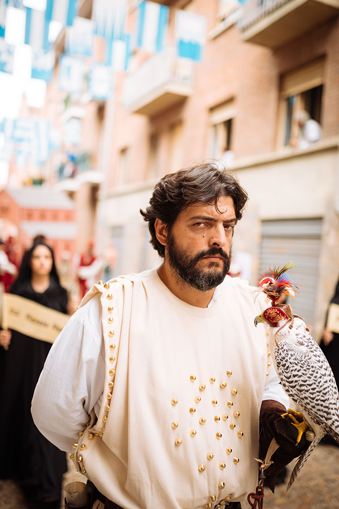 A man in a medieval costume takes part in a historical parade from the Piazza Cattedrale to the race track ahead of the Palio Di Asti on September 21, 2014 in Asti, Italy