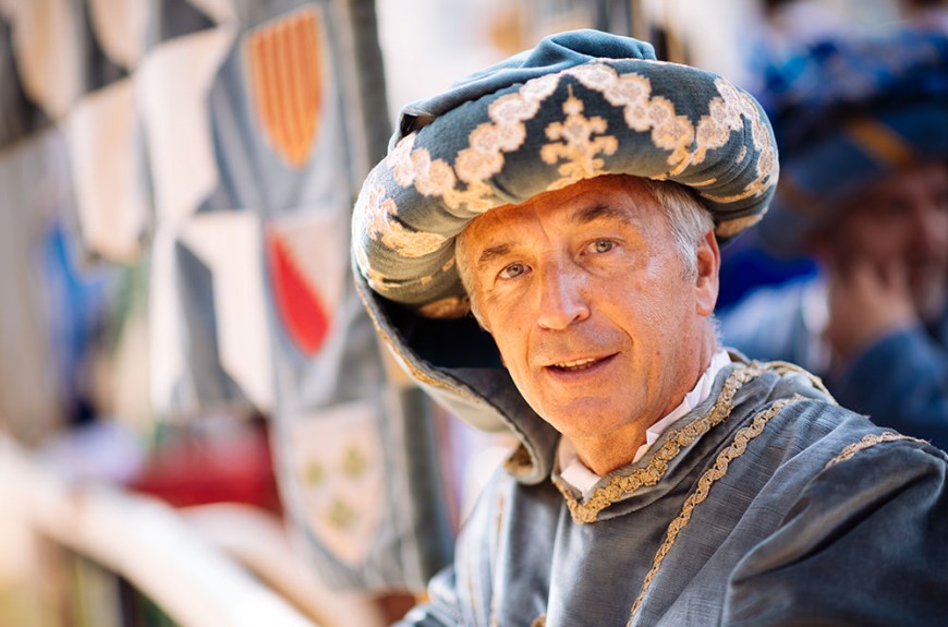 Portrait of man in traditional medieval costume ahead of the Palio di Asti
