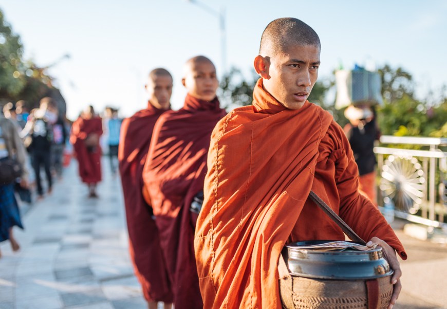 Buddhist monks collecting alms golden rock