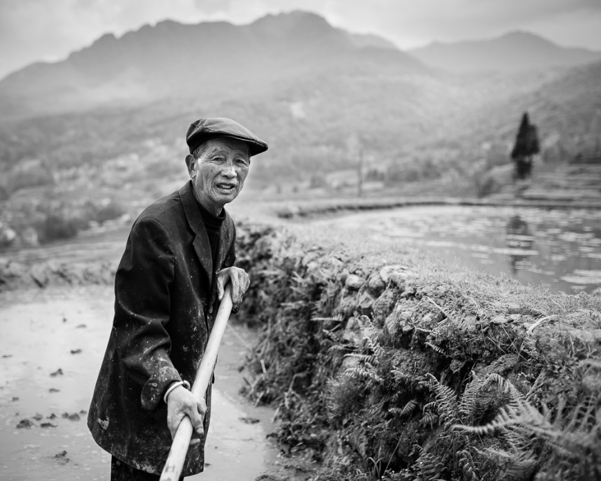 Farmer working in rice terrace, Duoyishu, Yuanyang, Yunnan Province, China