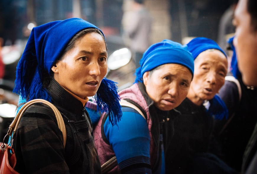 Women bartering over chicken sale at Xinjie Local Market, Yuanyang, Yunnan Province, China