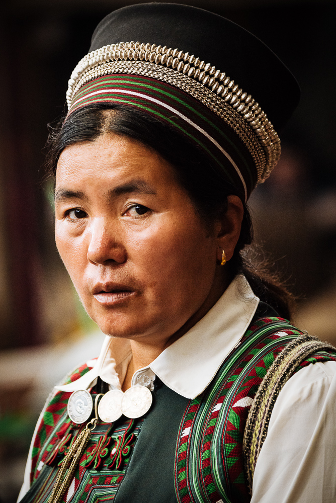 Portrait of traditionally dressed local woman, Xinjie Local Market, Yuanyang, Yunnan Province, China