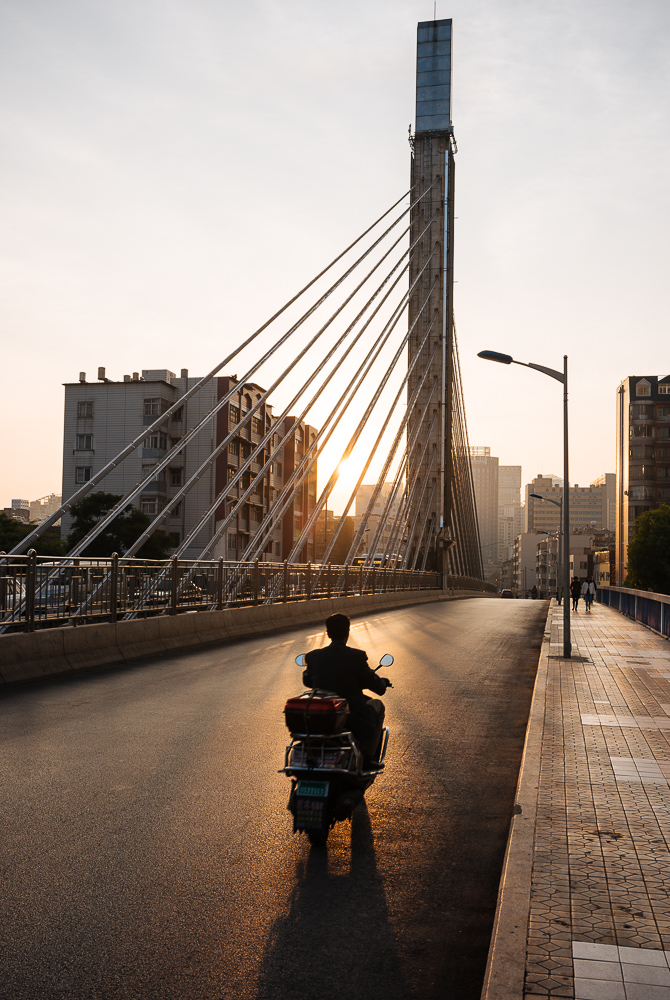 Sunrise behind modern bridge, Kunming, Yunnan Province, China