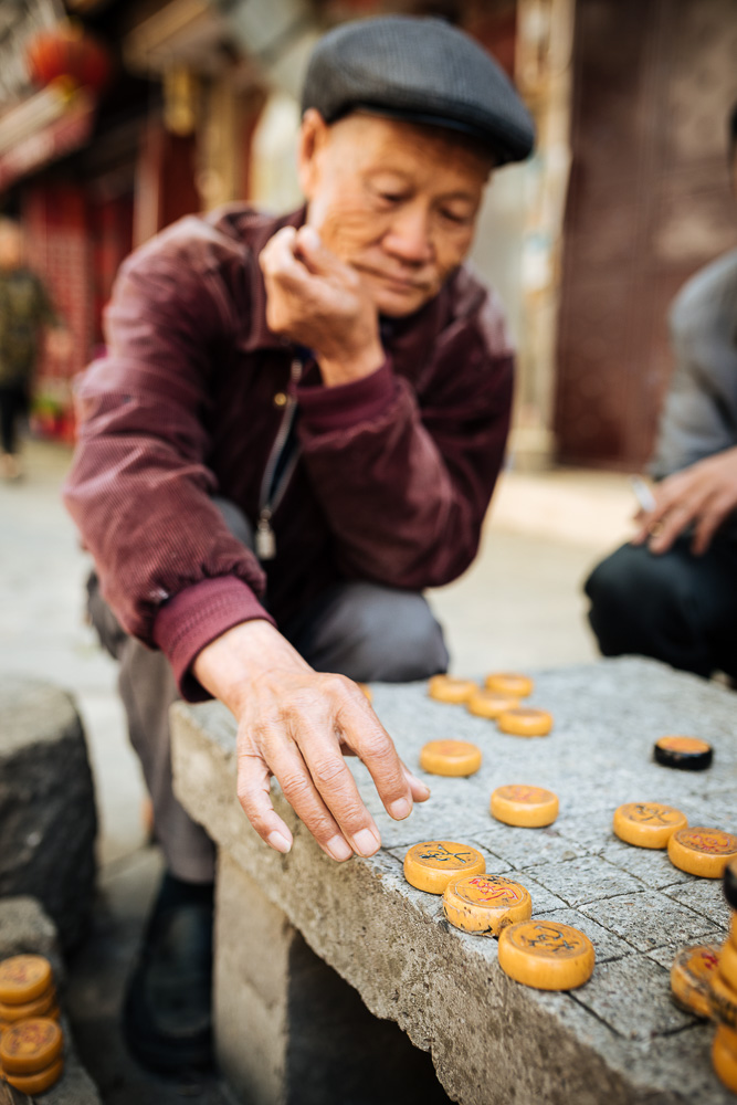 Men playing traditional game of Xiangqi (Chinese Chess), Dali, Yunnan Province, China