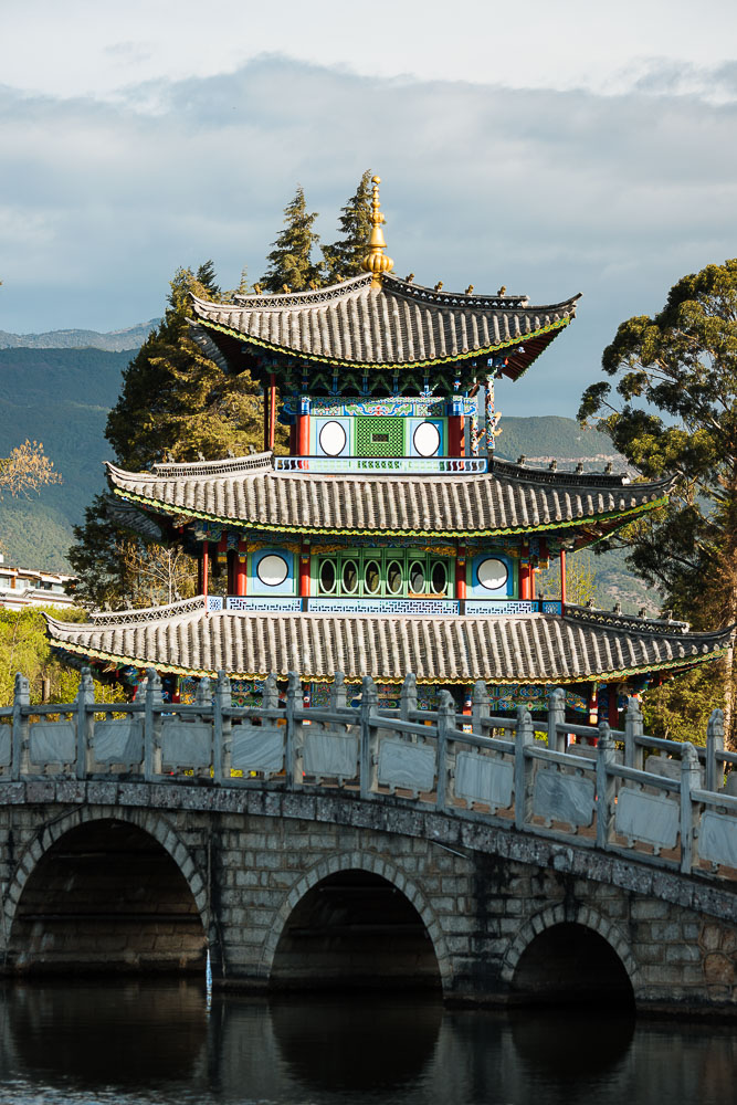 Moon Embracing Pavilion and bridge, Black Dragon Pool Park with Yulong Xueshan (Jade Dragon) Mountain, Lijiang, Yunnan Province, China