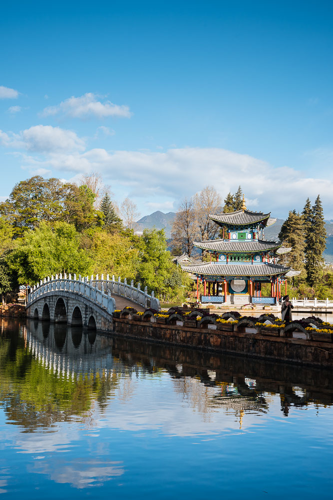 Moon Embracing Pavilion and bridge, Black Dragon Pool Park with Yulong Xueshan (Jade Dragon) Mountain, Lijiang, Yunnan Province, China